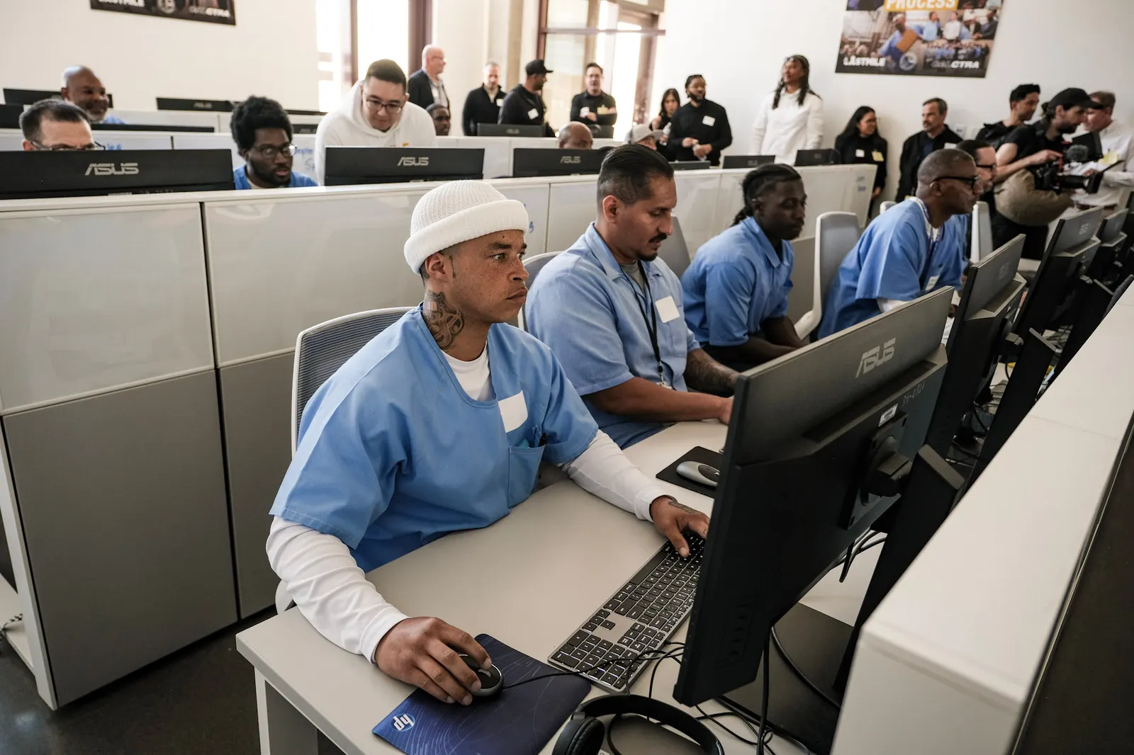 Students working at computers in a Last Mile classroom inside a correctional facility