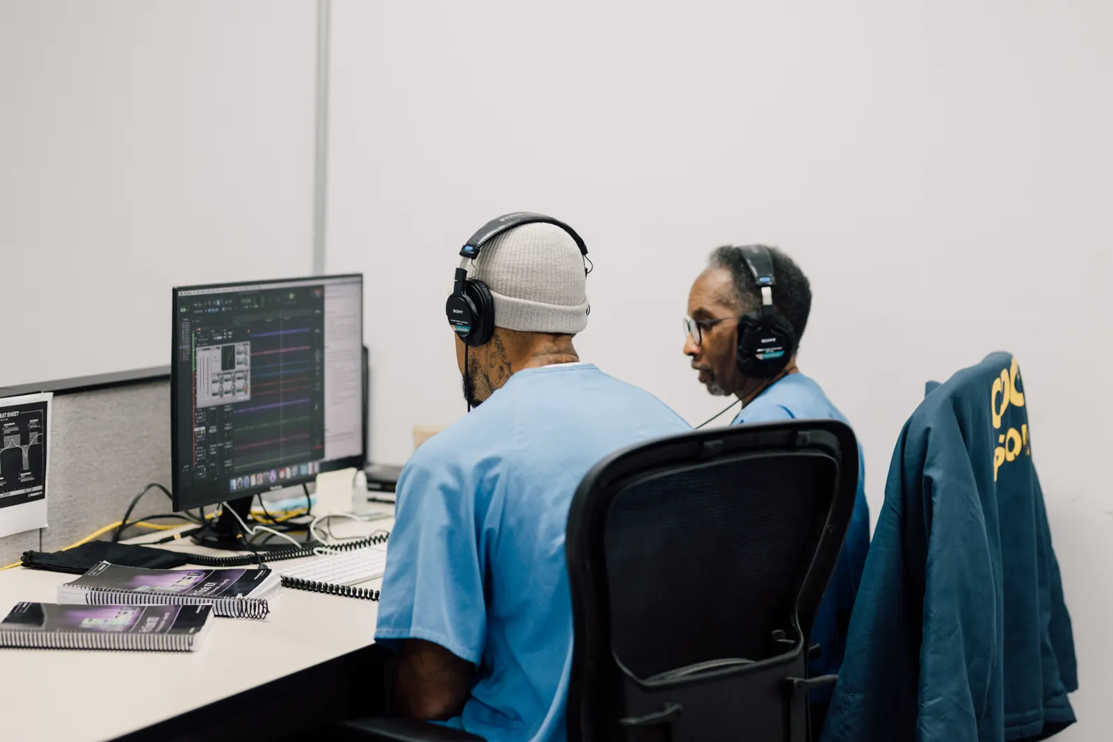Two students working together at a shared workstation in a Last Mile classroom